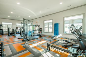 club quality fitness center with cardio and free weights at Anthem Luxury Rentals in Huntsville, AL